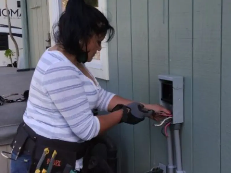 Licensed electrician wiring an exterior subpanel in Hewitt