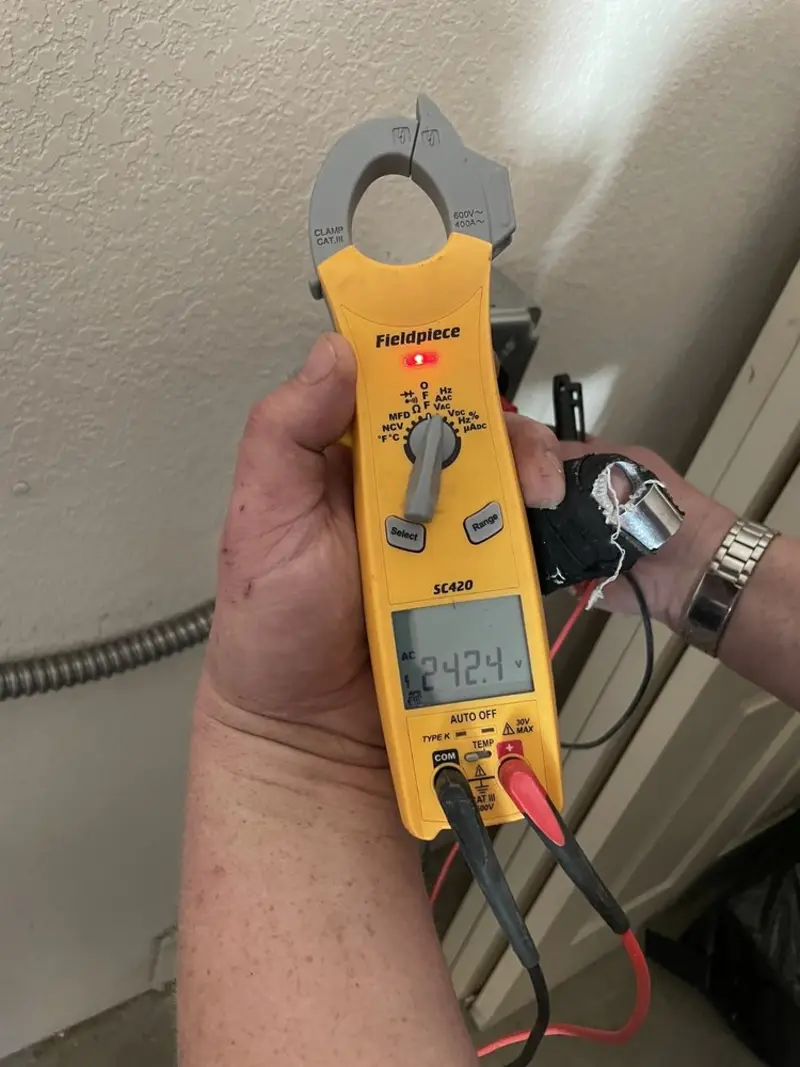 Voltage testing with clamp meter during Outlet Installation in Hewitt